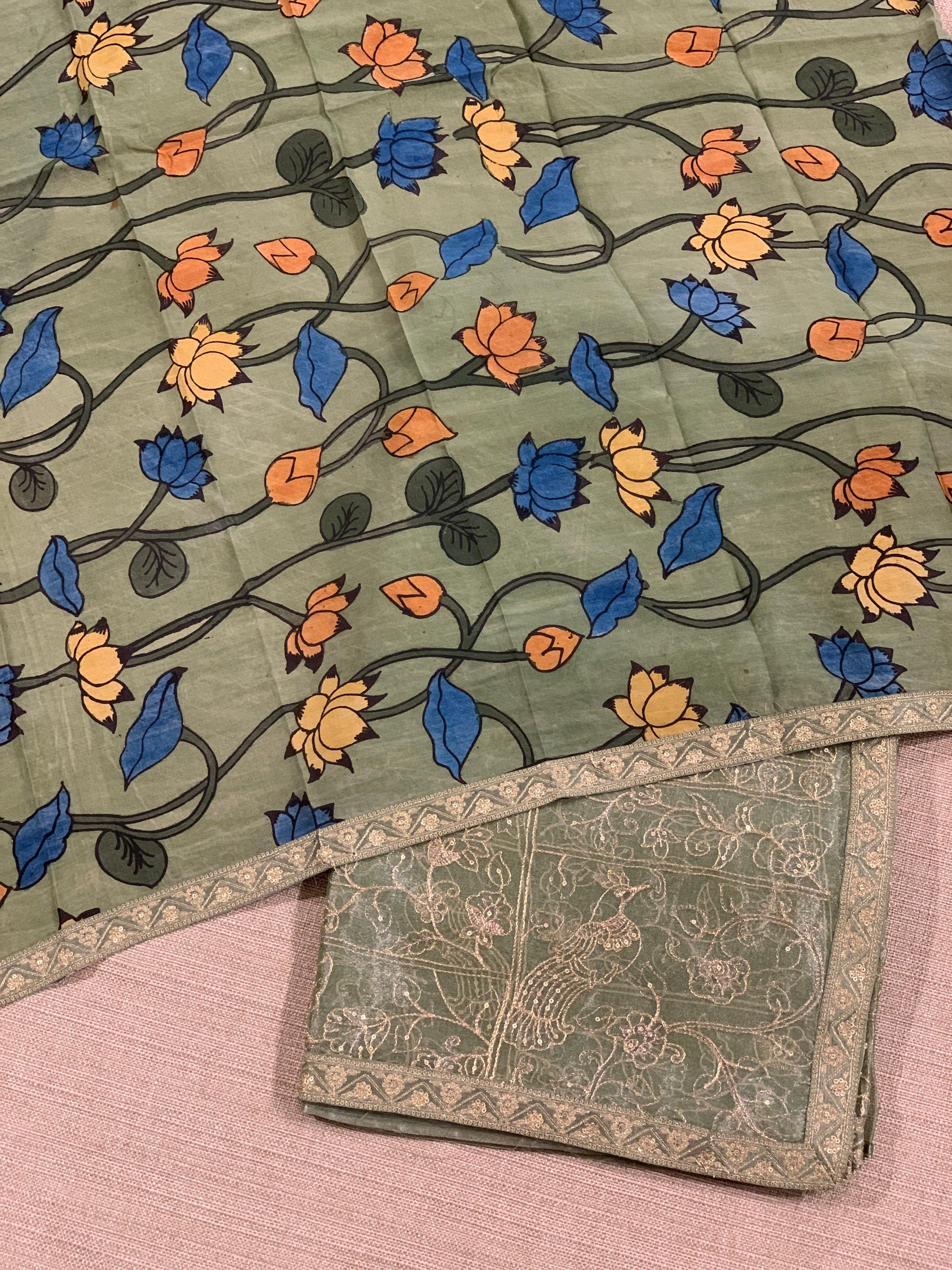Light olive Tissue saree with Allover zari embroidery hemlined with sabyasachi borders & paired with pen kalamkari blouse
