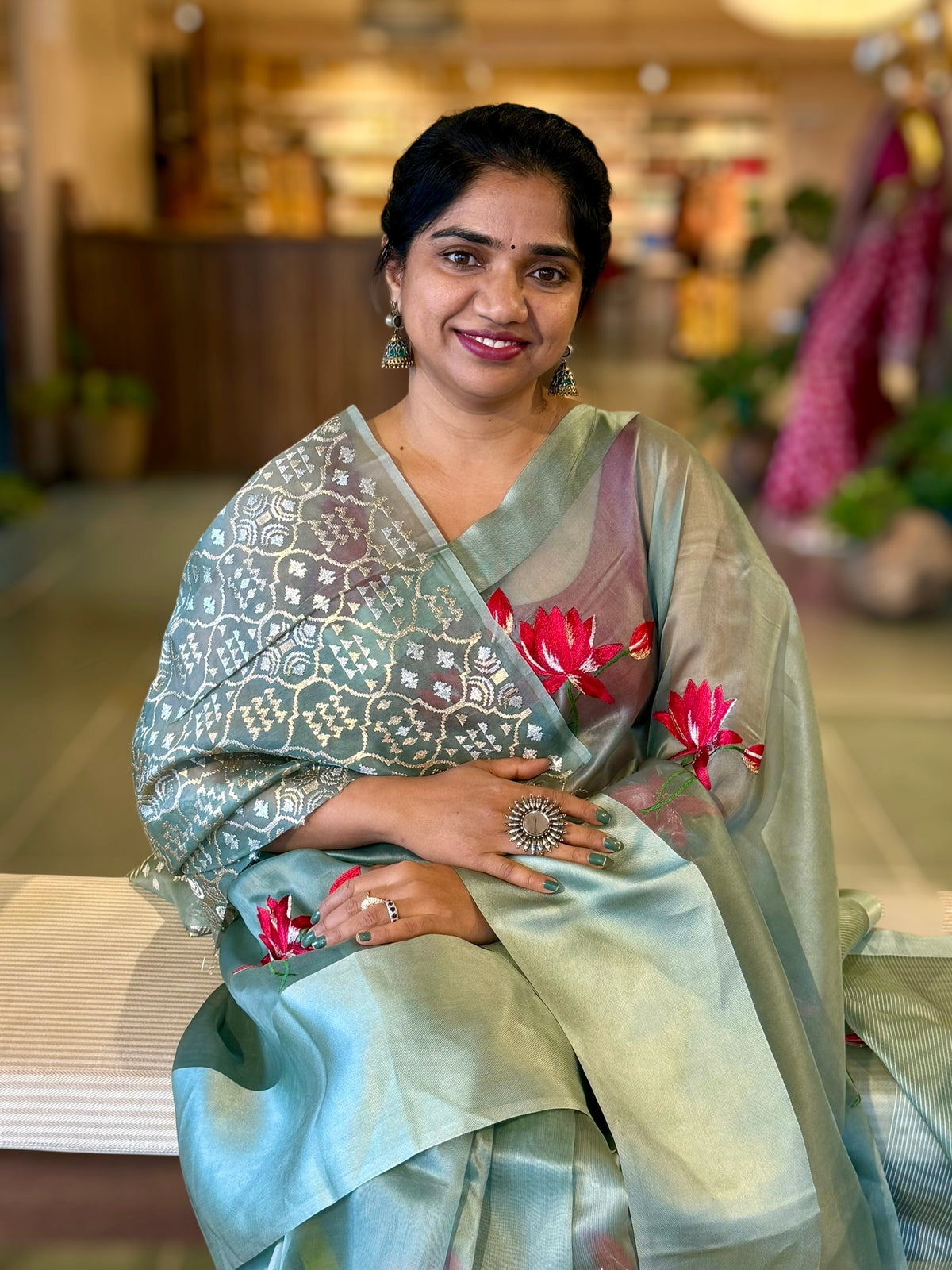 Teal Organza Saree with Lotus flower embroidery and Satin Borders.