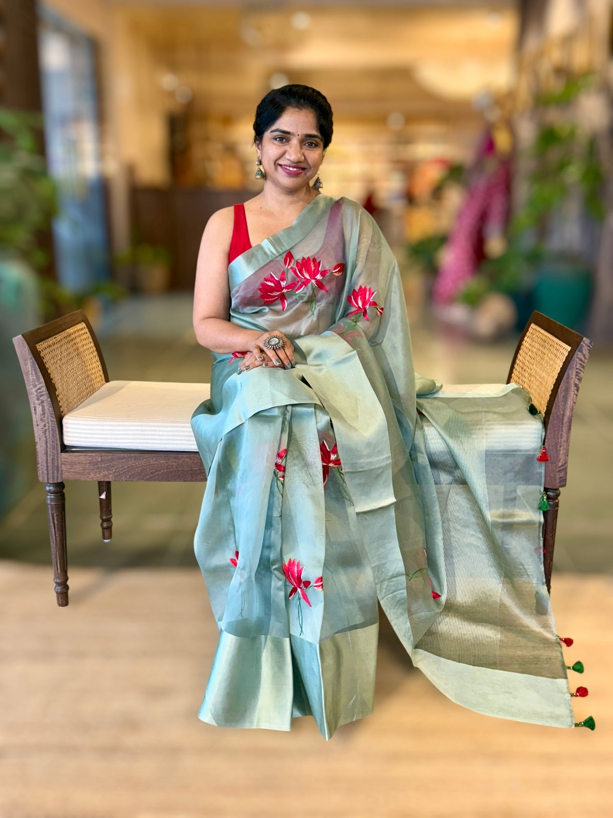Teal Organza Saree with Lotus flower embroidery and Satin Borders.