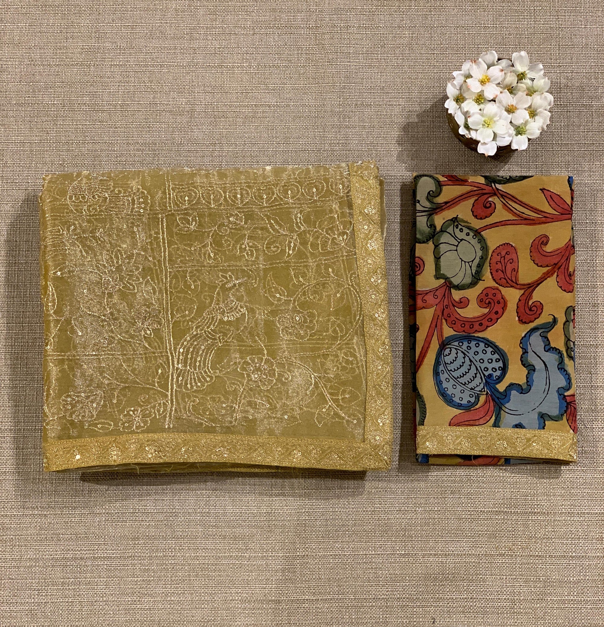 Yellow gold Tissue saree with Allover zari embroidery hemlined with sabyasachi borders & paired with pen kalamkari blouse