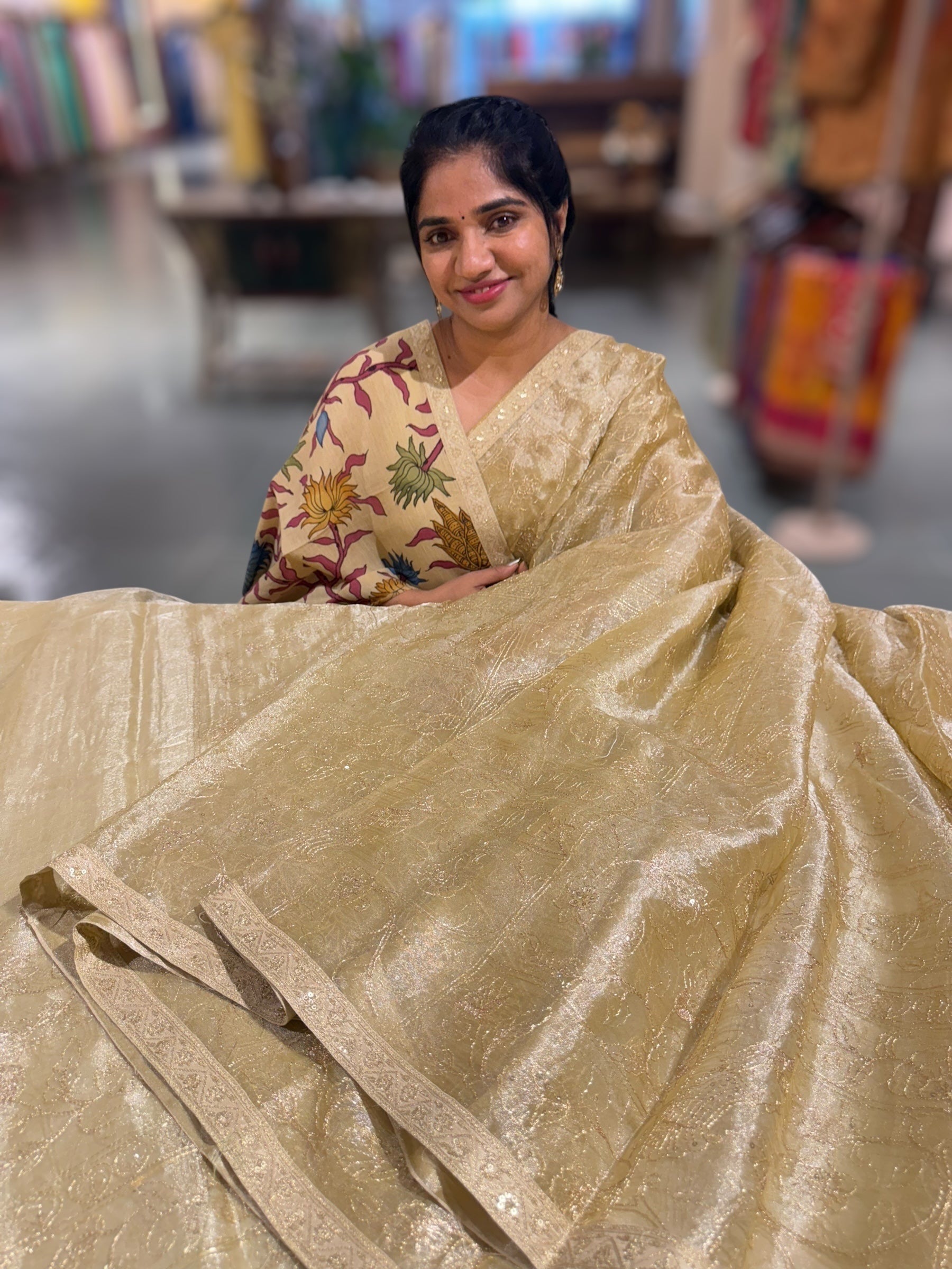 Beige Gold Tissue saree with Allover zari embroidery hemlined with sabyasachi borders & paired with pen kalamkari blouse