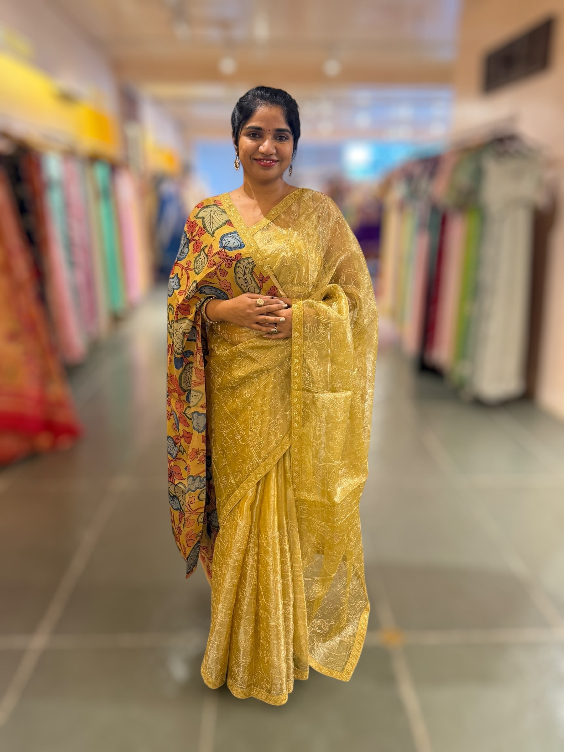 Yellow gold Tissue saree with Allover zari embroidery hemlined with sabyasachi borders & paired with pen kalamkari blouse