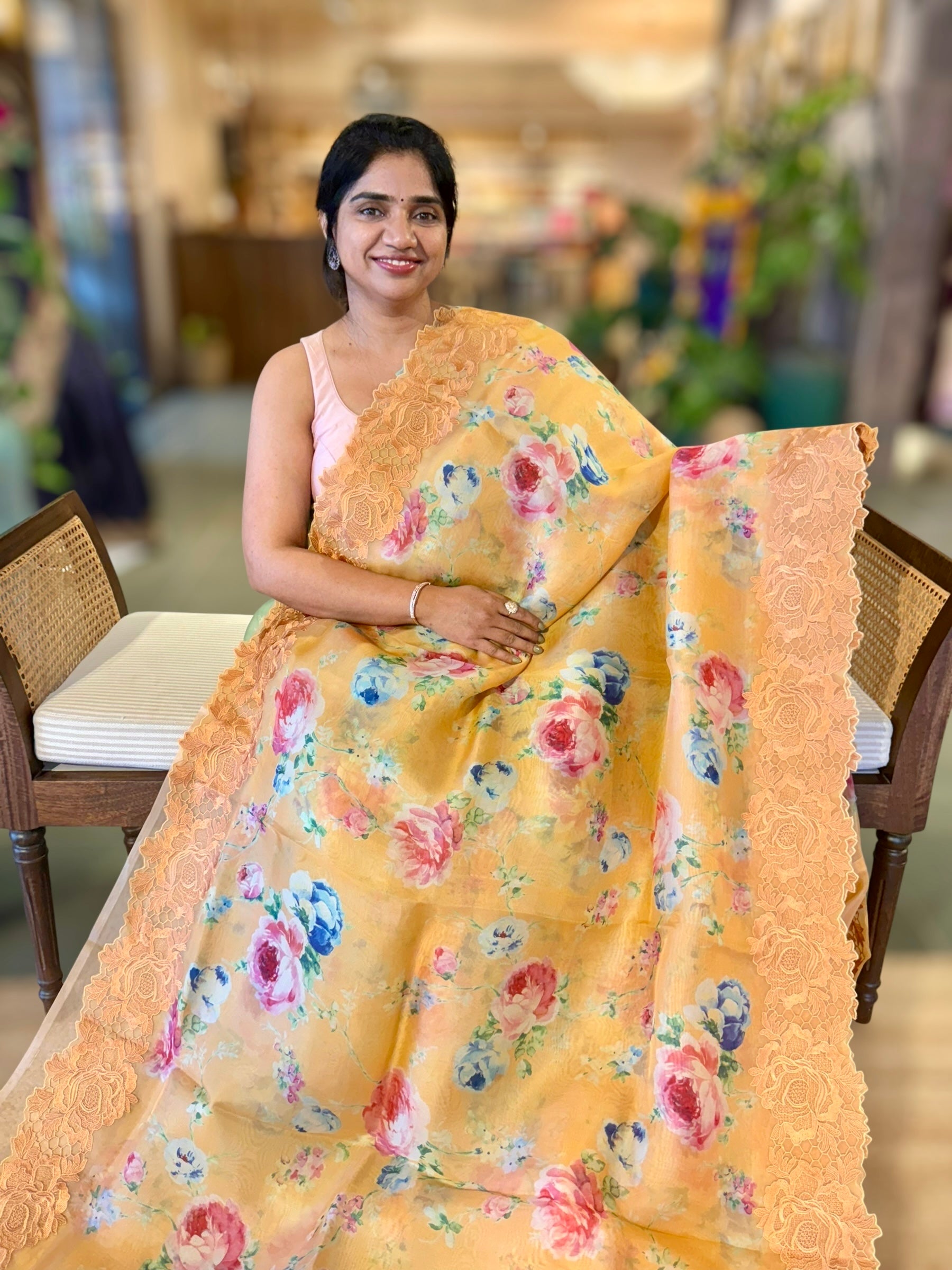 Mustardish Orange Printed Organza Saree With Chantilly Lace Style Embroidered Border.