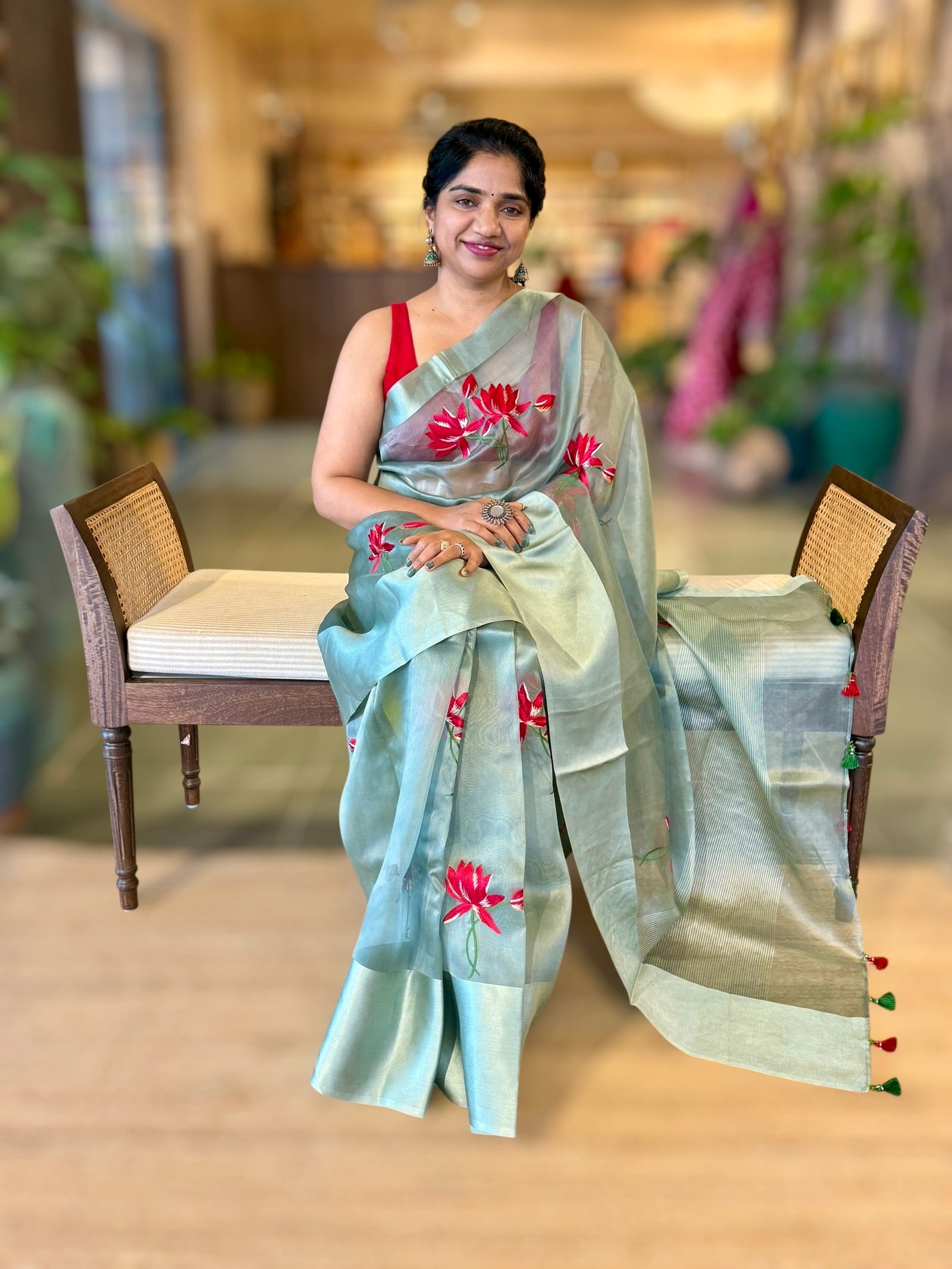 Teal Organza Saree with Lotus flower embroidery and Satin Borders.