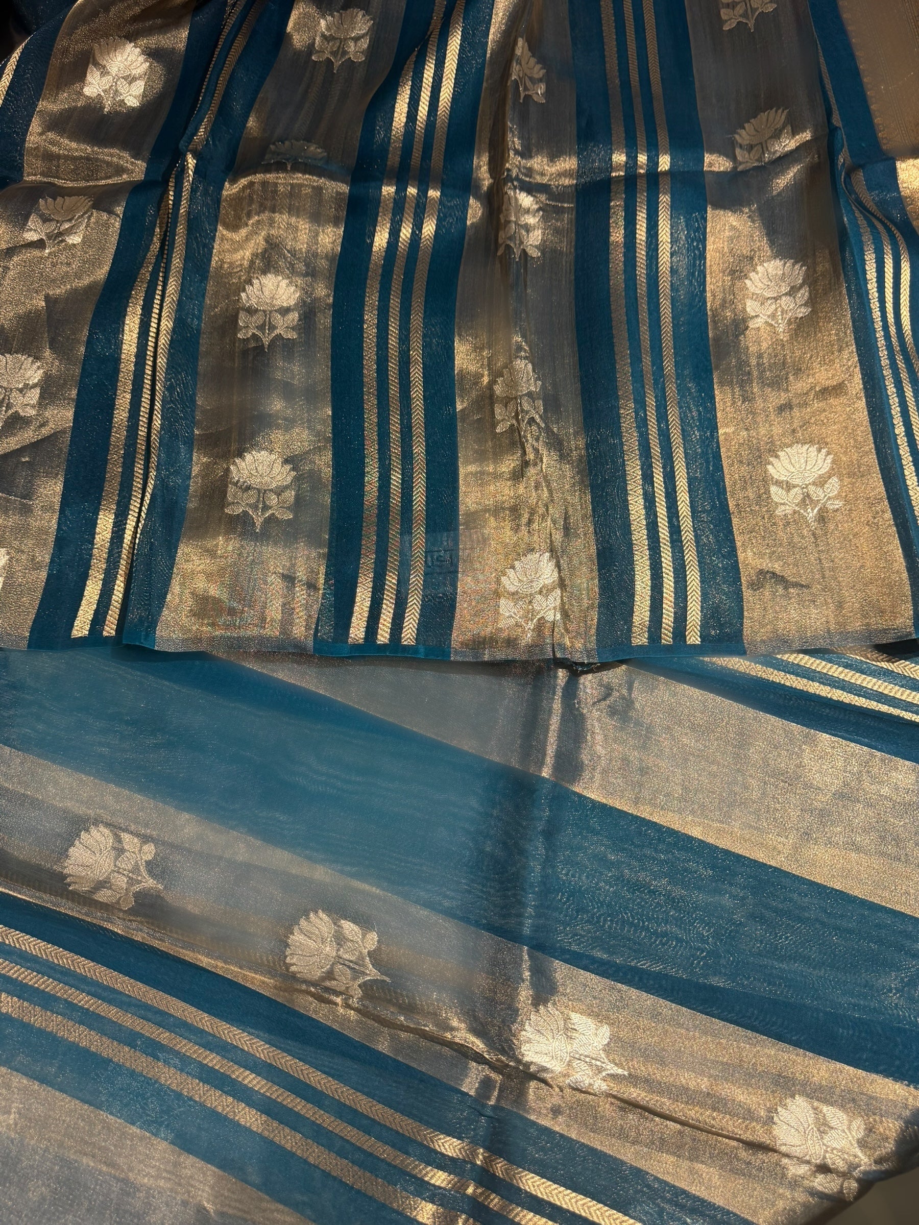Peacock Blue Banarasi Handloom Kora Tissue Stripes with allover kaduwa woven lotus  motifs .