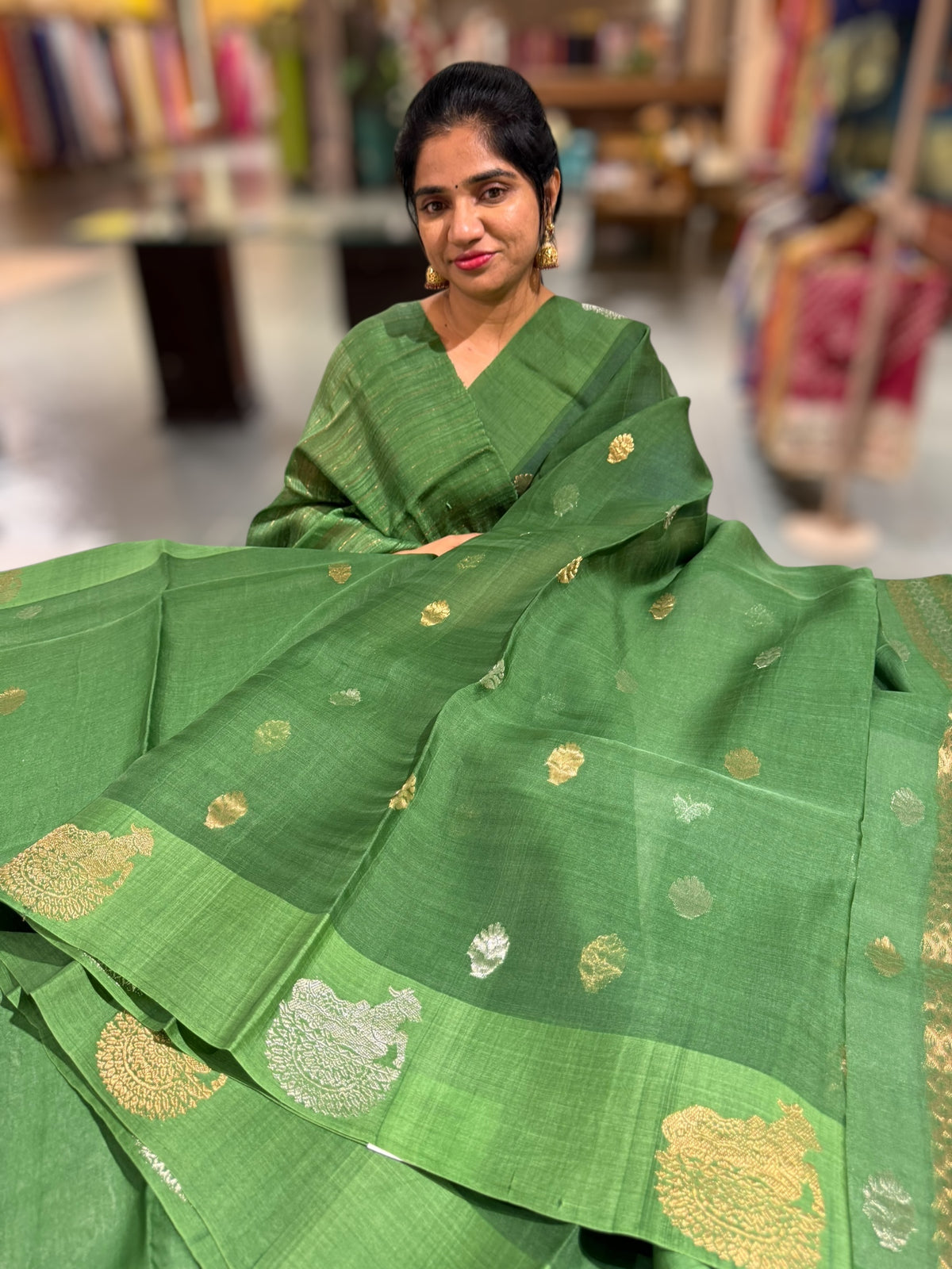 Emerald Green kora muslin sarees with kaduwa woven nandi motif border