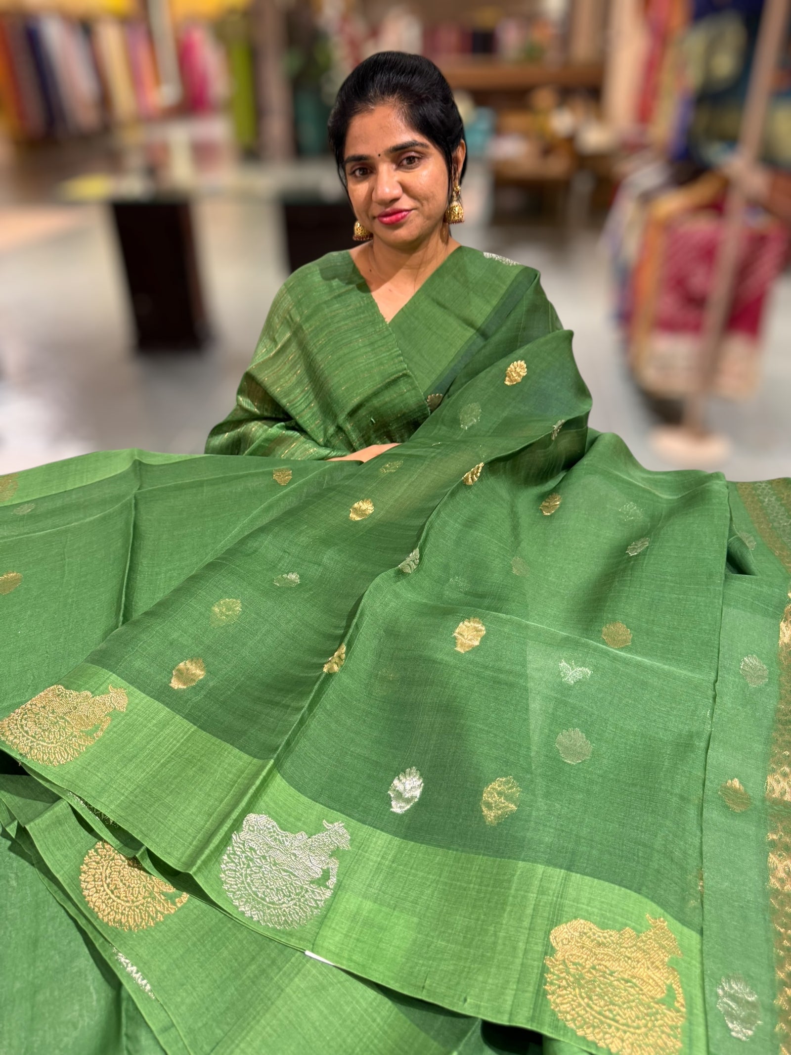 Emerald Green kora muslin sarees with kaduwa woven nandi motif border
