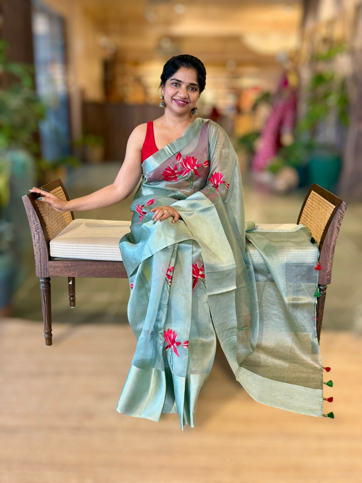 Teal Organza Saree with Lotus flower embroidery and Satin Borders.