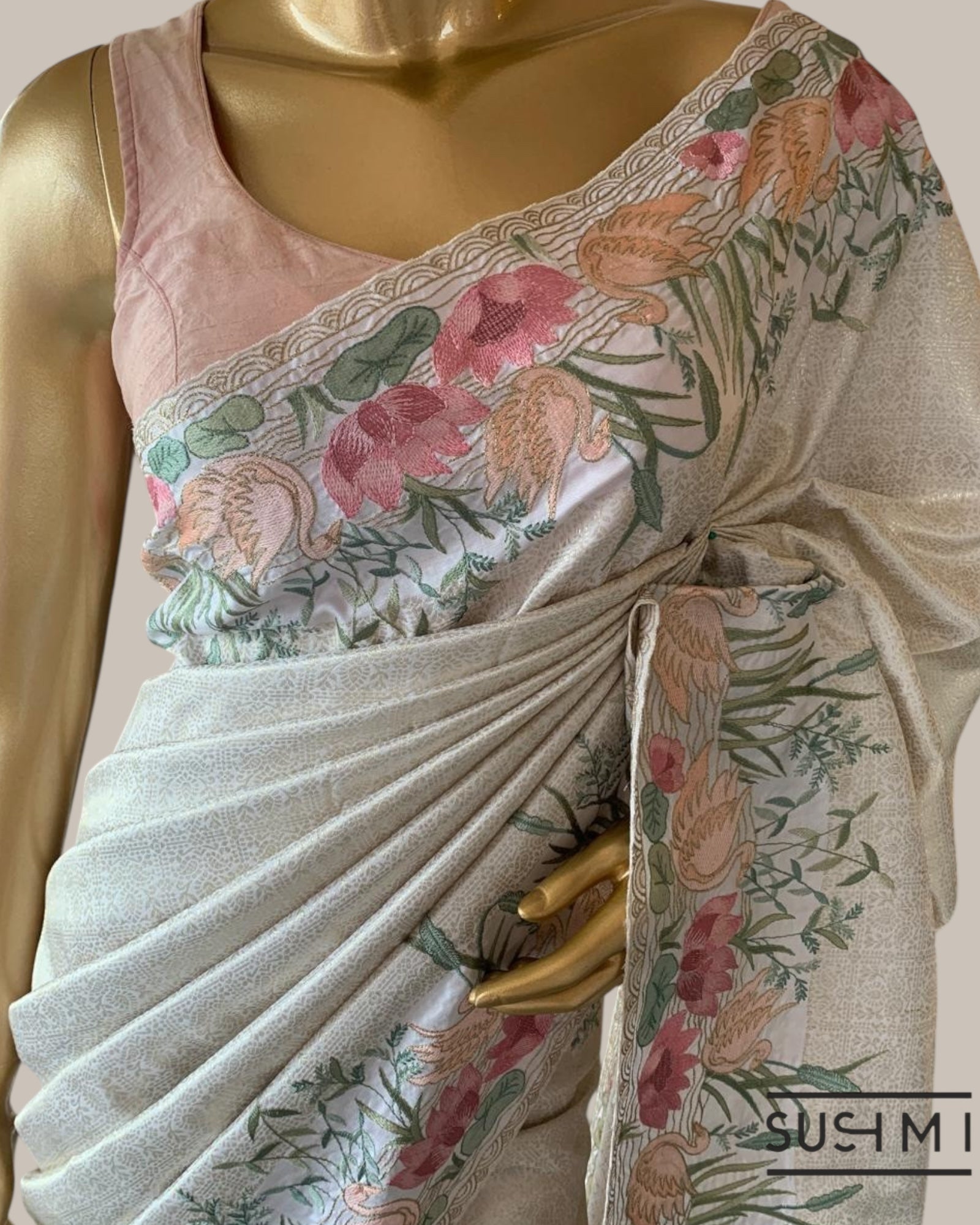 White Kanjeevaram Brocade Saree With Beautiful Pond Theme Embroidered Border.