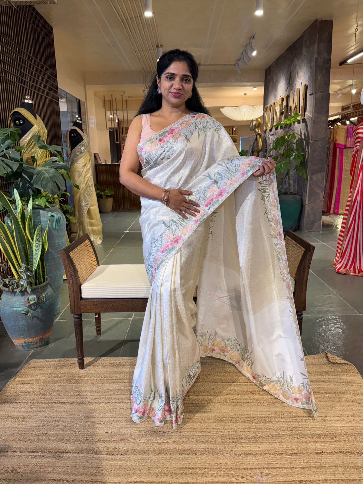 White Kanjeevaram Brocade Saree With Beautiful Pond Theme Embroidered Border.