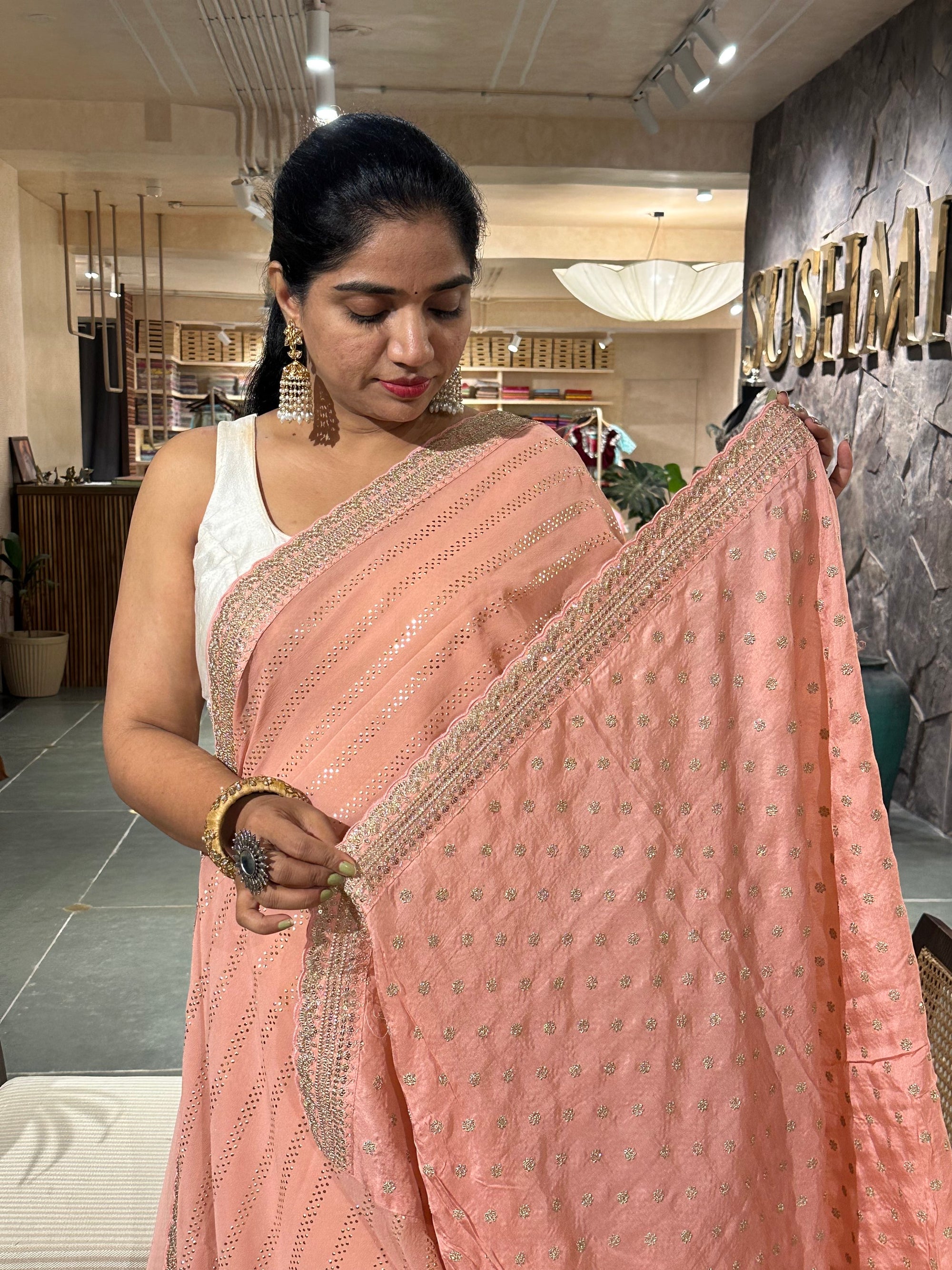 Salmon Pink Pure gorgette Saree with allover bead work  & sabyasachi borders