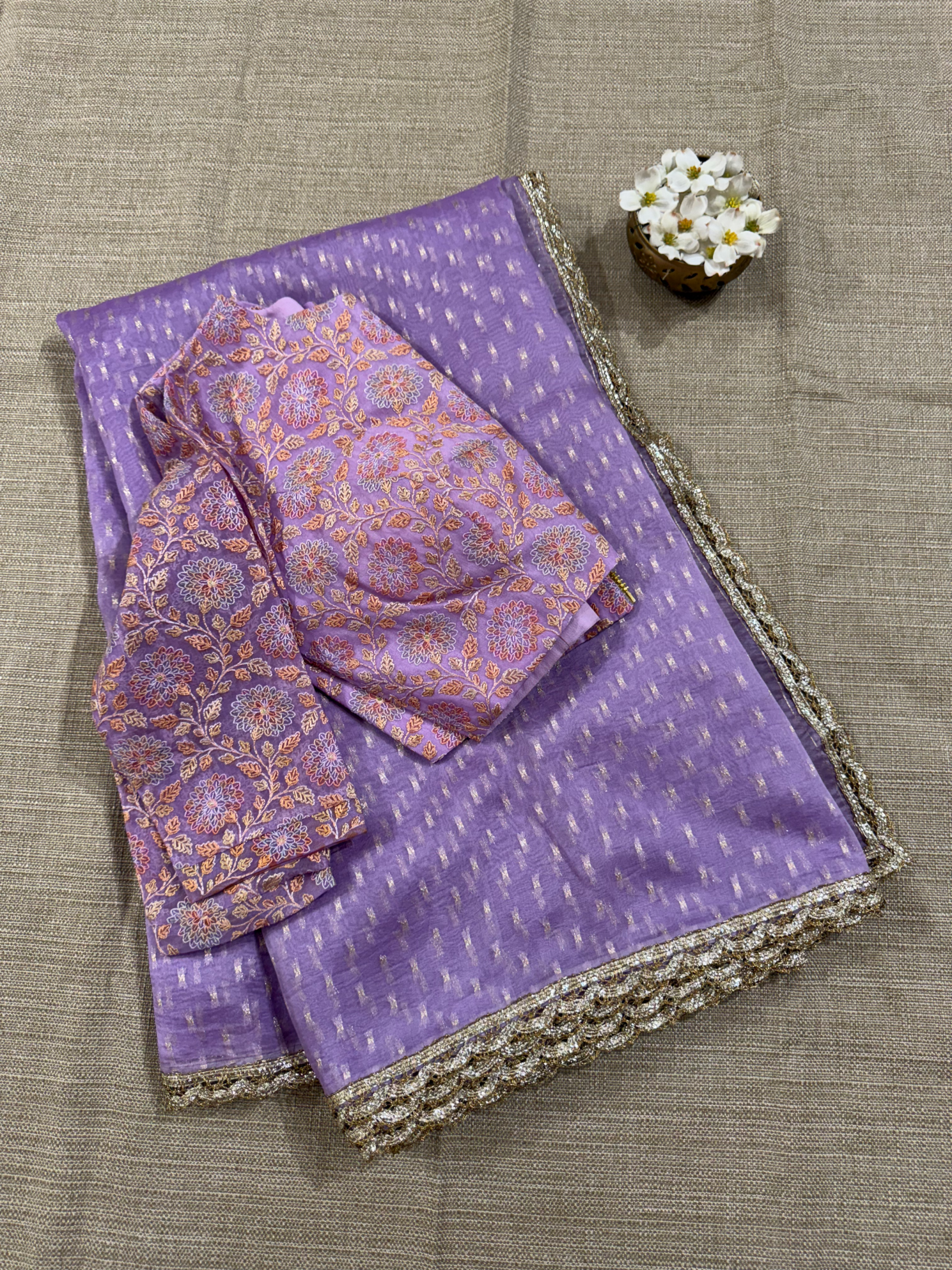 Lilac Pure Organza Saree with allover zari butis paired with Embroidered Blouse