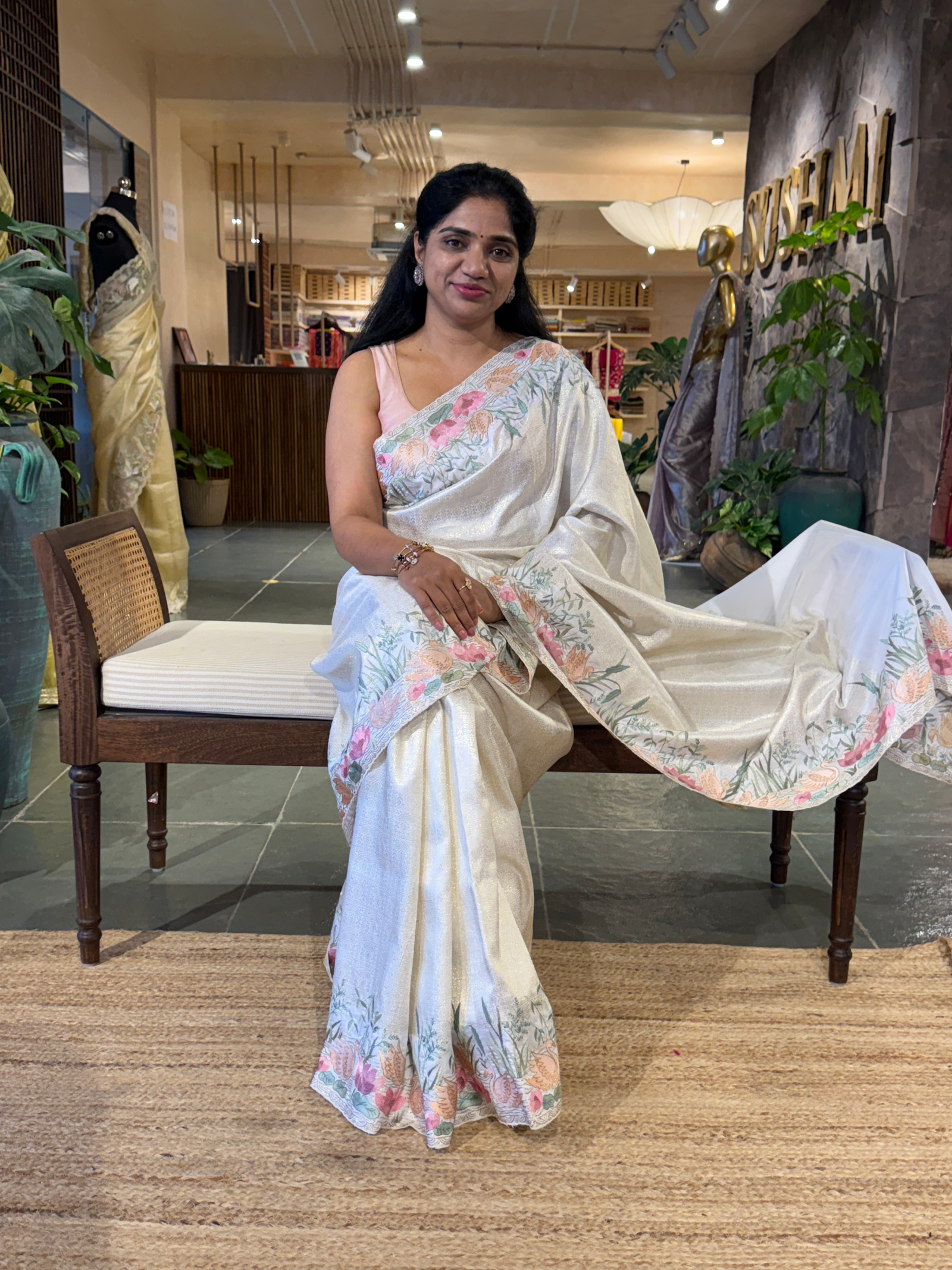 White Kanjeevaram Brocade Saree With Beautiful Pond Theme Embroidered Border.