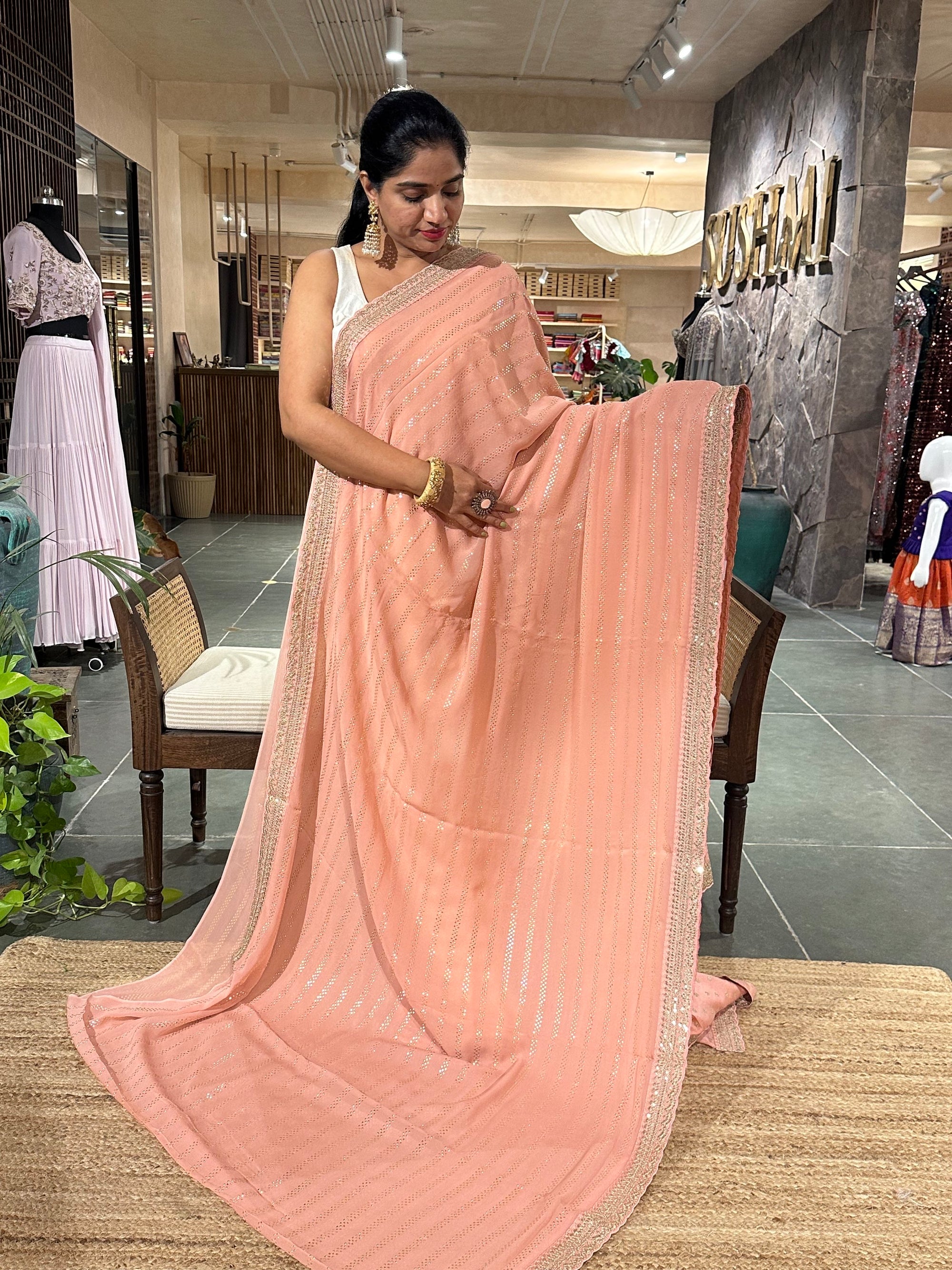 Salmon Pink Pure gorgette Saree with allover bead work  & sabyasachi borders