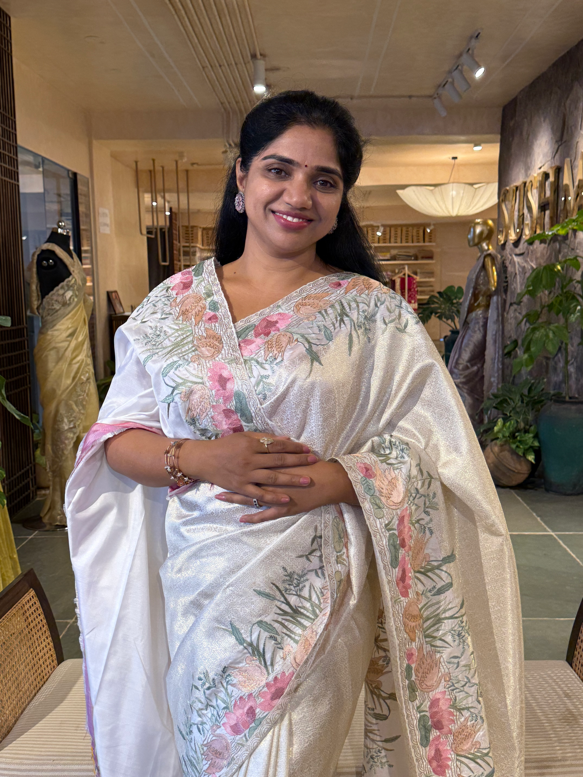 White Kanjeevaram Brocade Saree With Beautiful Pond Theme Embroidered Border.