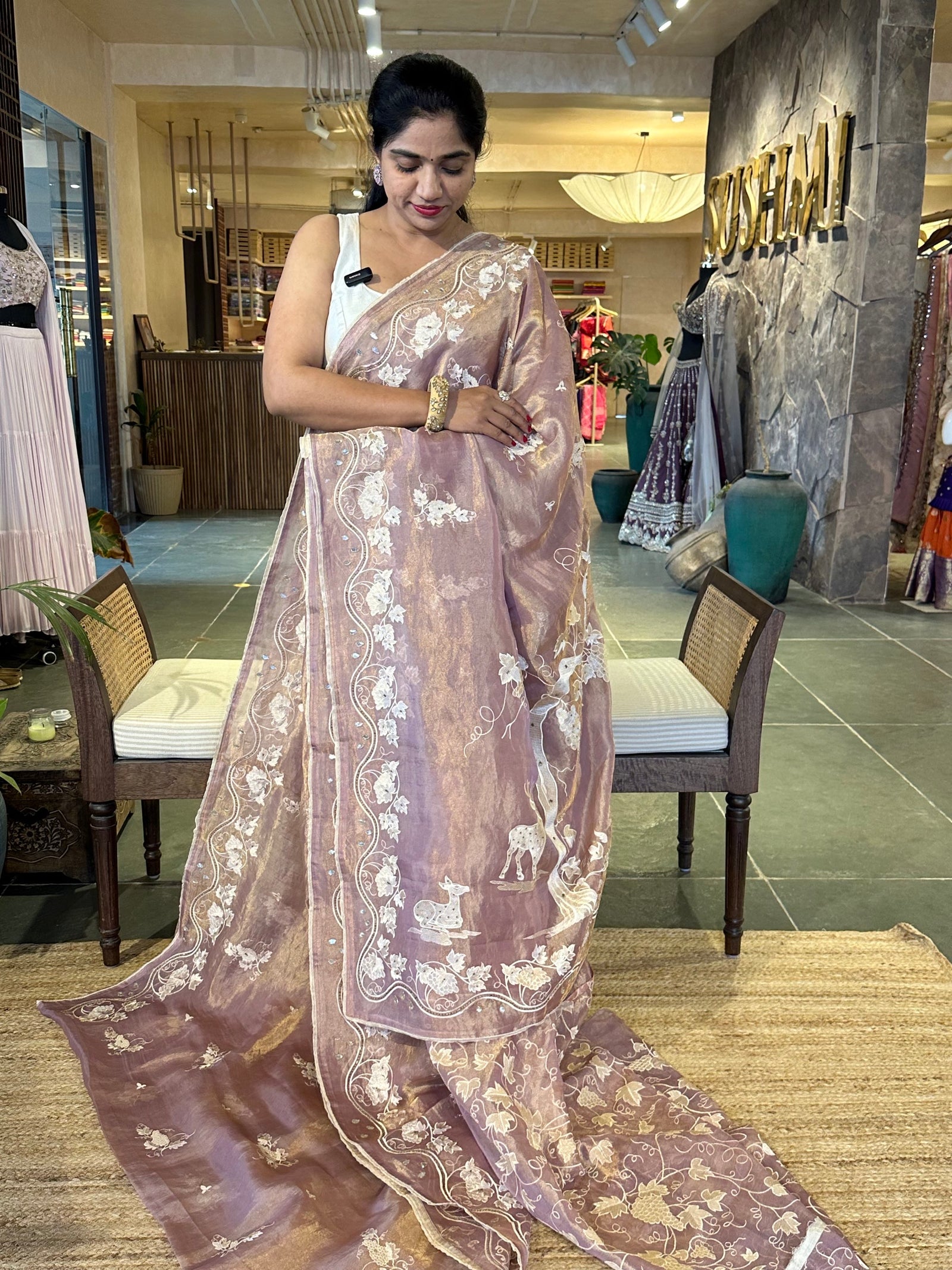 Mauve Tissue saree with allover embroidery and handwork highlighting .