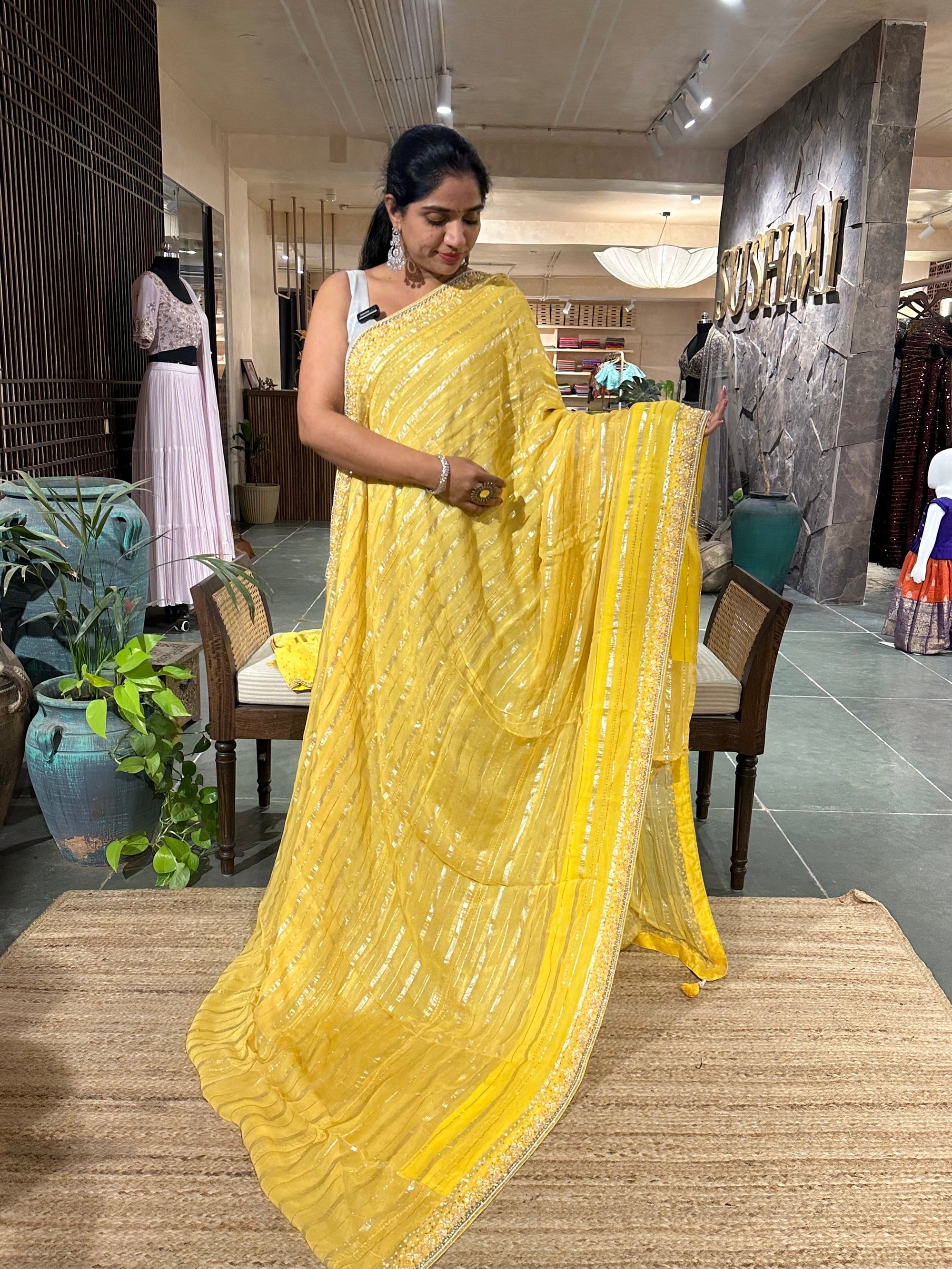 Yellow shaded Chiffon Saree  with  golden stripes , handwork on saree Blouse