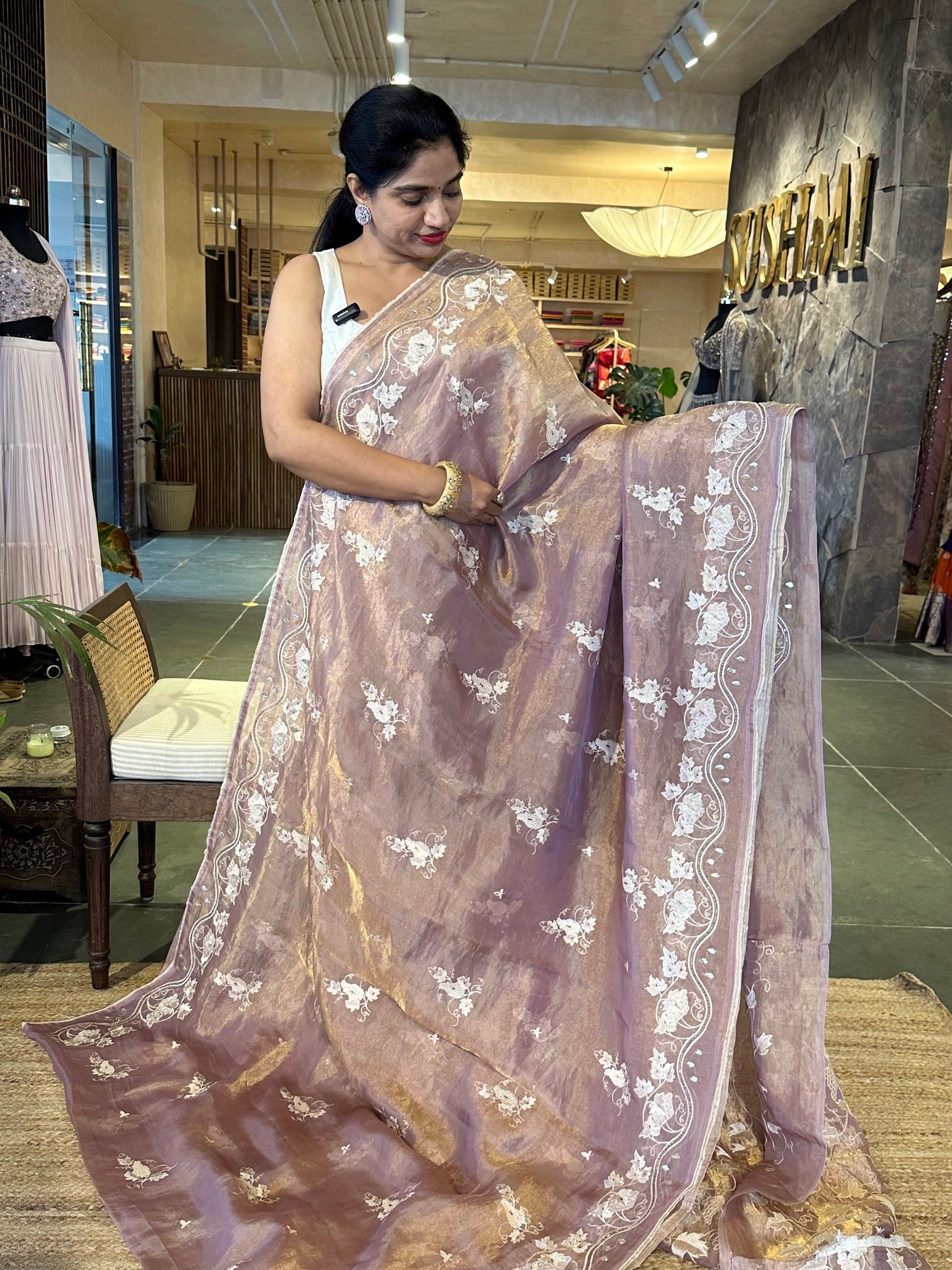 Mauve Tissue saree with allover embroidery and handwork highlighting .