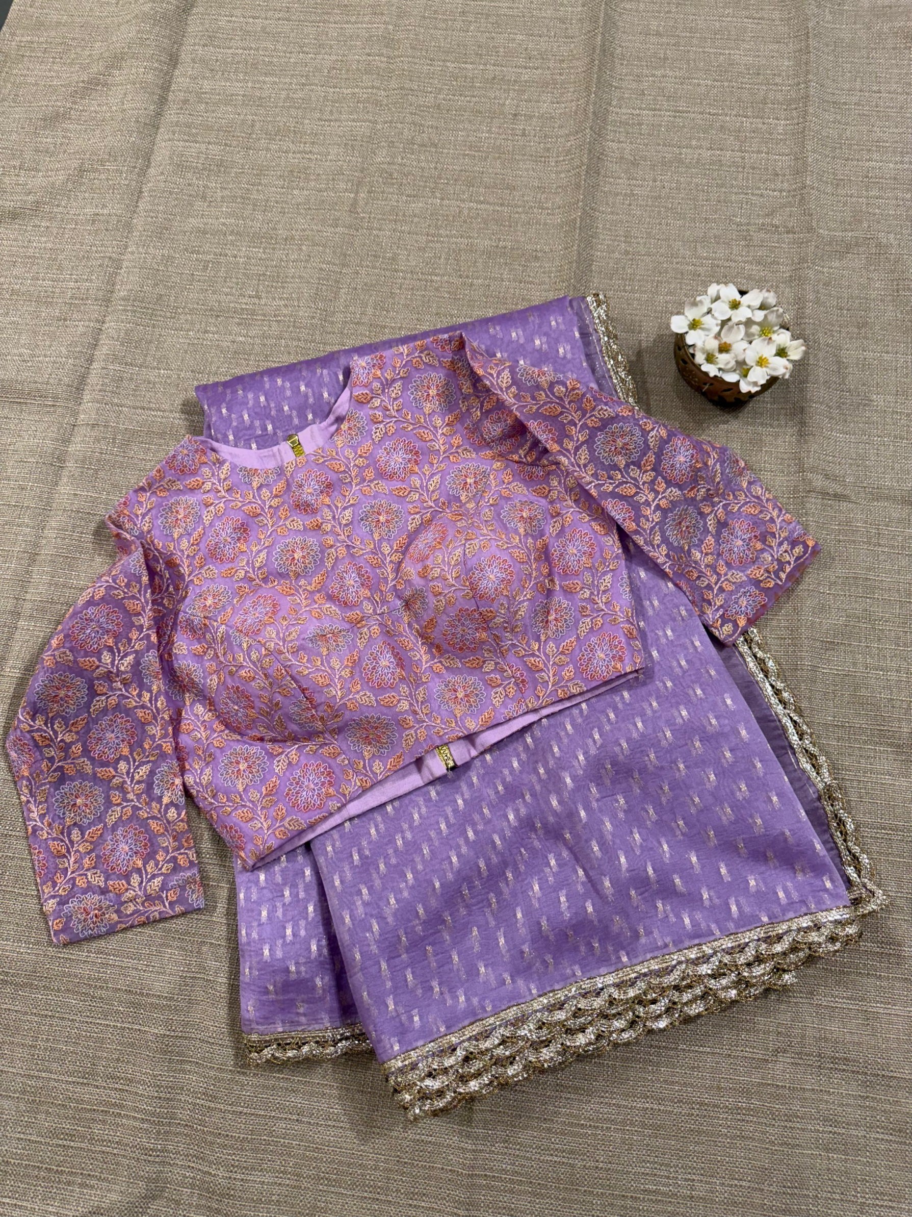 Lilac Pure Organza Saree with allover zari butis paired with Embroidered Blouse