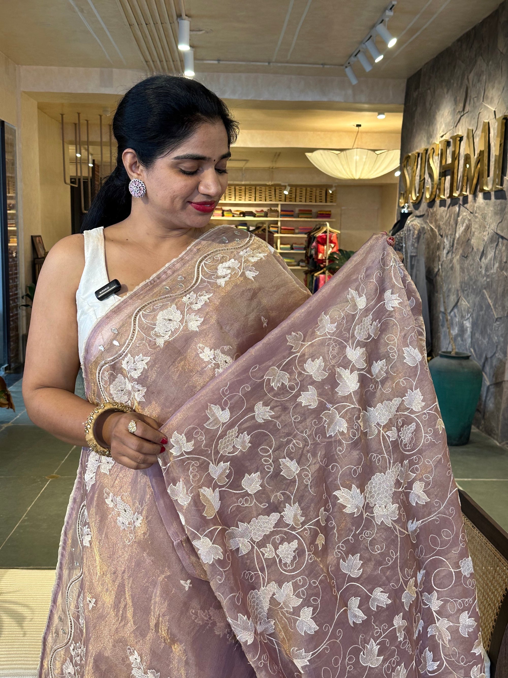 Mauve Tissue saree with allover embroidery and handwork highlighting .