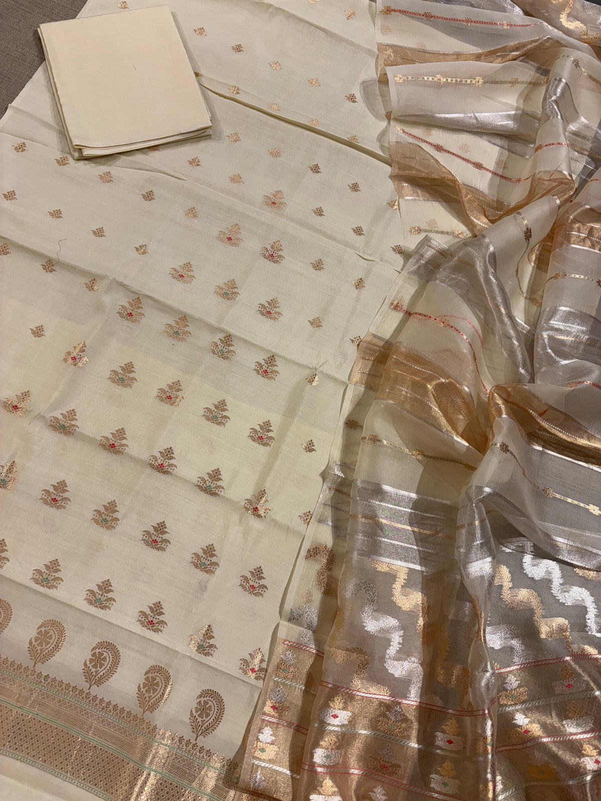 Ivory color Chiniya silk suit set with oaduwa woven meenakari motifs paired with heavy kora banarasi dupatta